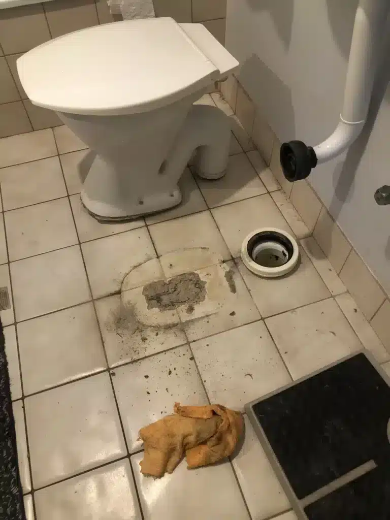 Plumbers preparing for a blocked toilet repair