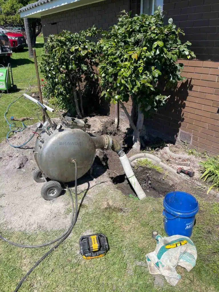 Pipe relining equipment set up on a residential property in Merimbula