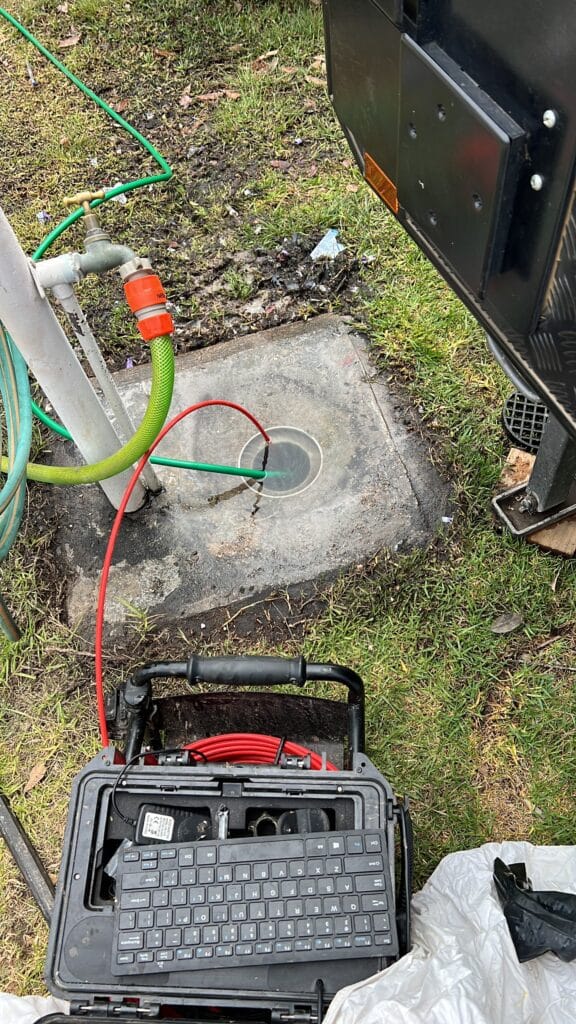 A blocked drain being cleared in Bega