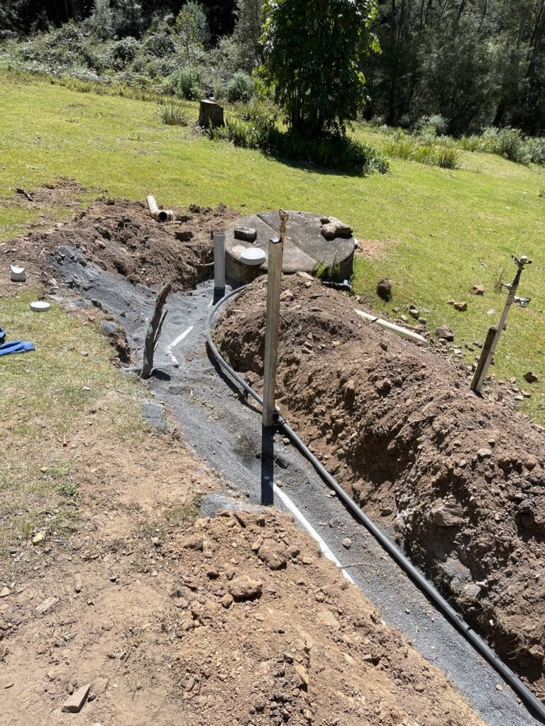 the keogh plumbing team repairing a septic tank line in Tanja, NSW