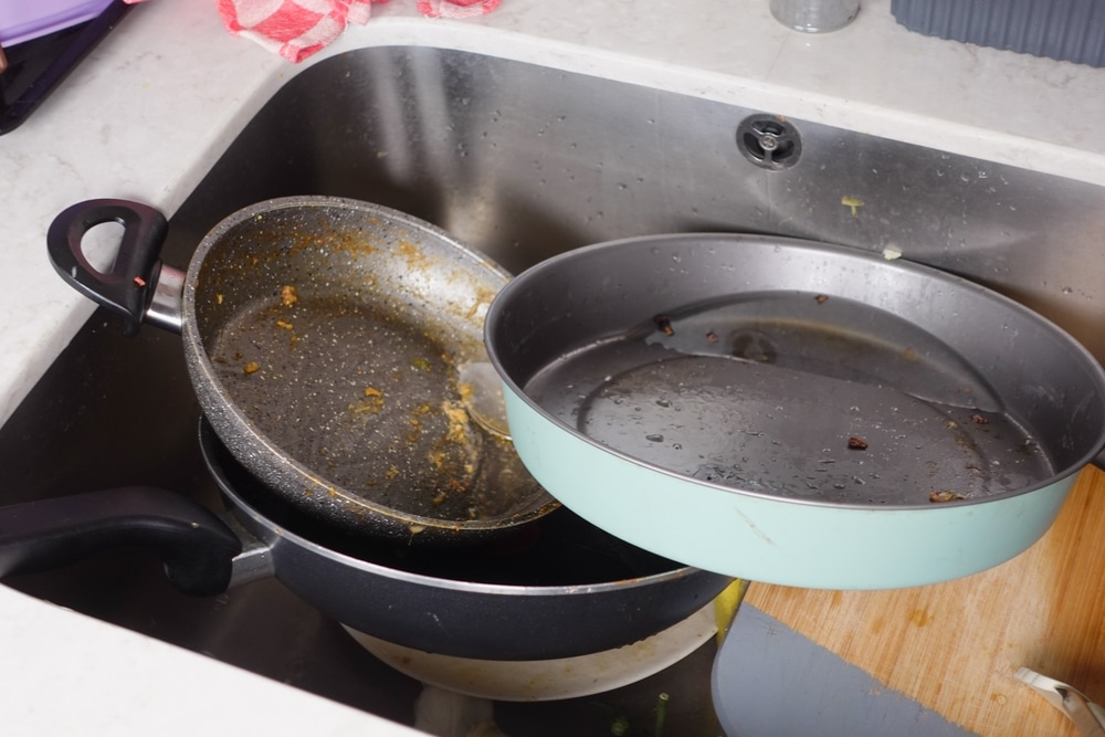 dirty dishes stacked in the kitchen sink