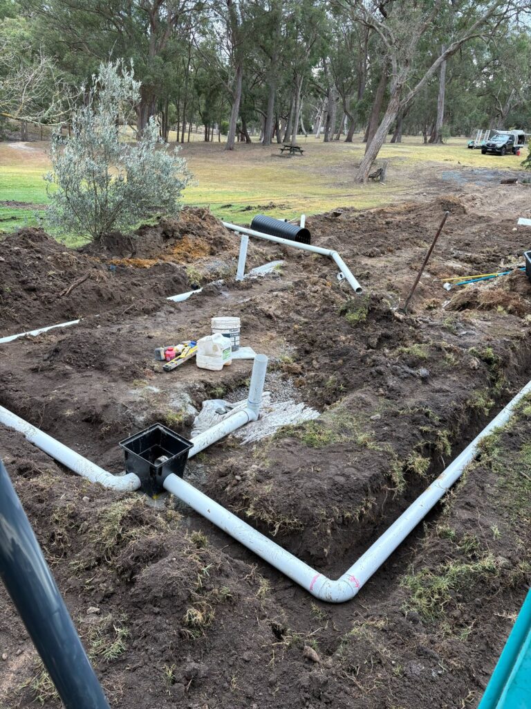 New septic distribution box and disposal lines before backfill at a Kanoona property