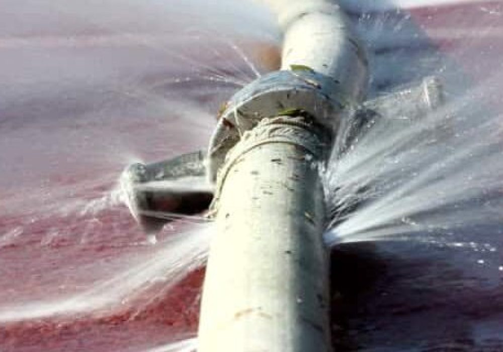 wasting water - water leaking from hole in a hose